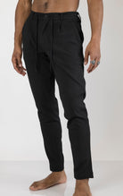 Men's front pleated waffle pants in black. The pants are made from a textured waffle fabric (95% cotton, 5% elastane) and feature a relaxed fit, front pleats, and a comfortable elastic waistband.