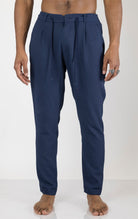 Men's front pleated waffle pants in navy. The pants are made from a textured waffle fabric (95% cotton, 5% elastane) and feature a relaxed fit, front pleats, and a comfortable elastic waistband.