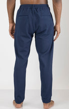 Men's front pleated waffle pants in navy. The pants are made from a textured waffle fabric (95% cotton, 5% elastane) and feature a relaxed fit, front pleats, and a comfortable elastic waistband.