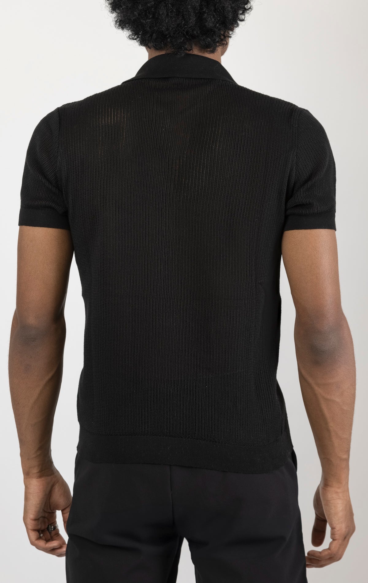 Men's see-through button-down mesh top in black. The top is made from a 50% cotton, 50% acrylic blend and features a tailored fit with a sheer mesh fabric and button-down closure.