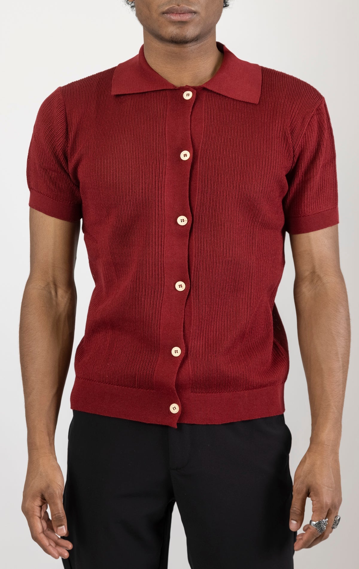 Men's see-through button-down mesh top in burgundy. The top is made from a 50% cotton, 50% acrylic blend and features a tailored fit with a sheer mesh fabric and button-down closure.