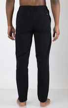 Men's wrinkle-free tapered travel pants in black. The pants are made from a blend of polyamide (88%) and elastane (12%) and feature a tapered fit, wrinkle-resistant fabric, and multiple pockets.