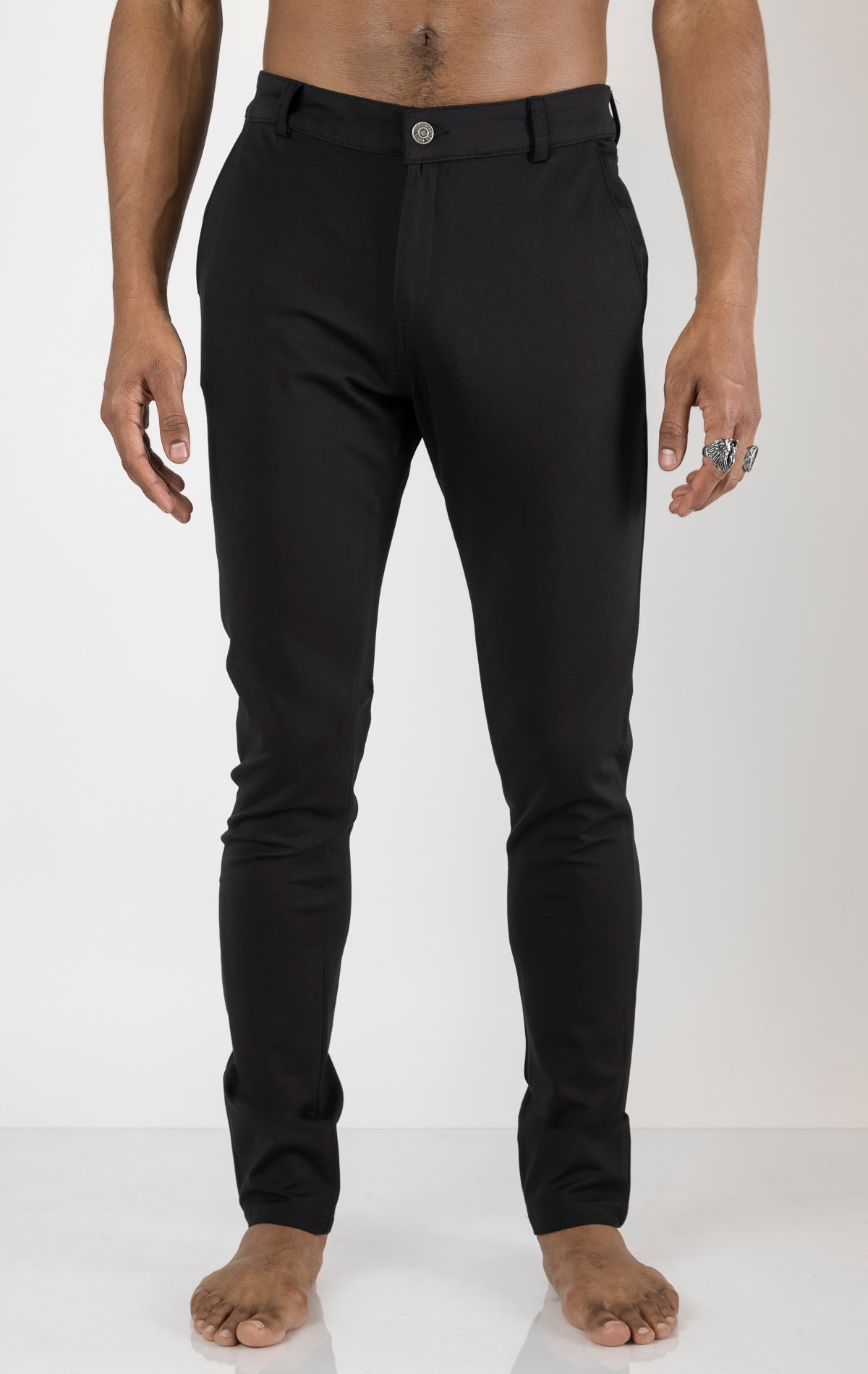 Men's casual wear pants in black. The pants are made from a blend of rayon (65%), nylon (27%), and elastane (8%) and feature a classic design with straight or tapered legs, belt loops, pockets, and a zip fly with button closure.