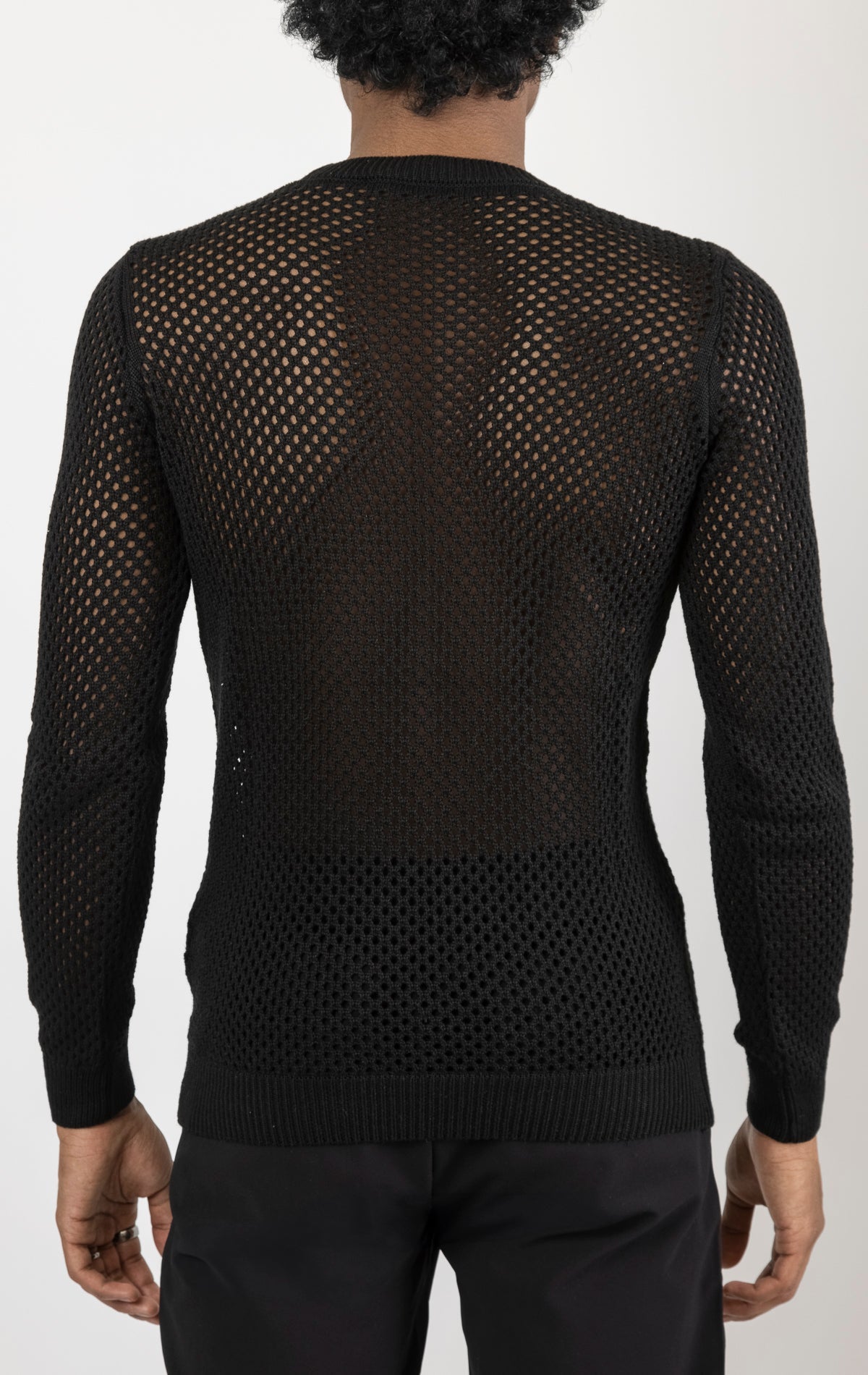 Men's see-through fishnet muscle fit shirt in black. The shirt is made from a 50% cotton, 50% acrylic blend and features a muscle fit silhouette with a see-through fishnet fabric design.