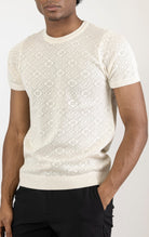 Women's geometric crochet knit top in beige. The top is made from a 50% viscose, 50% polyamide blend and features a unique geometric crochet pattern.