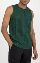 Men's knit muscle fit tank top in green. The tank top is made from a 50% cotton, 50% acrylic blend and features a muscle fit cut, sleeveless construction, and a textured knit fabric.