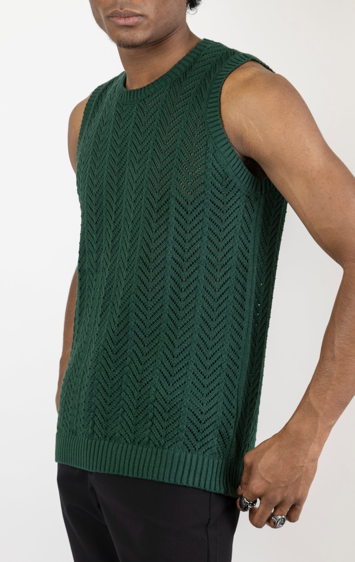 Men's knit muscle fit tank top in green. The tank top is made from a 50% cotton, 50% acrylic blend and features a muscle fit cut, sleeveless construction, and a textured knit fabric.