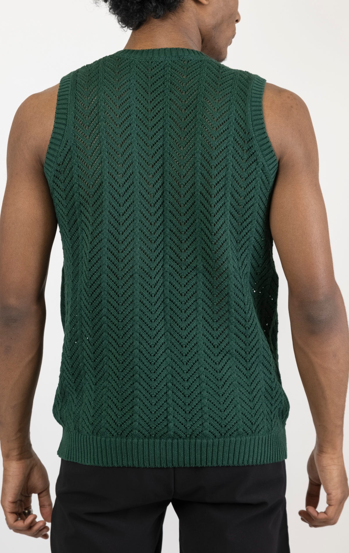 Men's knit muscle fit tank top in green. The tank top is made from a 50% cotton, 50% acrylic blend and features a muscle fit cut, sleeveless construction, and a textured knit fabric.