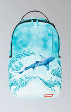 Sprayground backpack with shark graphic, gold zippers and metal hardware featuring multiple compartments and pockets, including a separate velour laptop compartment and a velour sunglass compartment. It has ergonomic mesh back padding, adjustable straps, and a slide-through back sleeve for attaching to carry-on luggage.  The backpack is made from durable 900D polyester fabric.