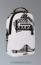 White Sprayground backpack with a captivating AI tribal design. Features multiple compartments including a separate velour laptop compartment, side pockets, and a hidden zippered pocket. Equipped with ergonomic mesh back padding, adjustable straps, and a slide-through back sleeve for attaching to carry-on luggage. Made from durable water-resistant faux leather.