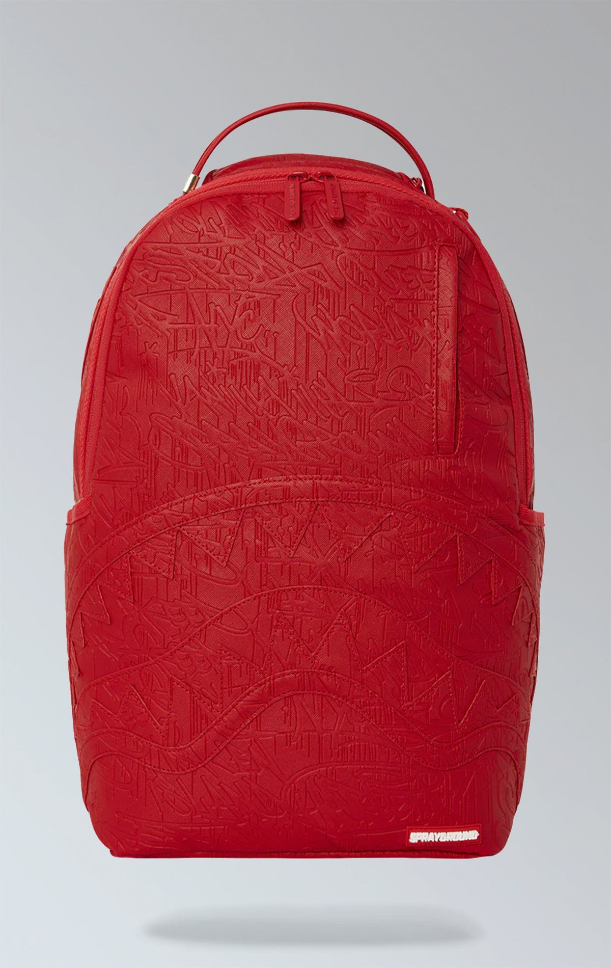 Red Sprayground backpack with an eye-catching scribble design. Features multiple compartments including a separate velour laptop compartment, side pockets, and a hidden zippered pocket. Equipped with ergonomic mesh back padding, adjustable straps, and a sliding back sleeve for attaching to carry-on luggage. Made from durable vegan leather.