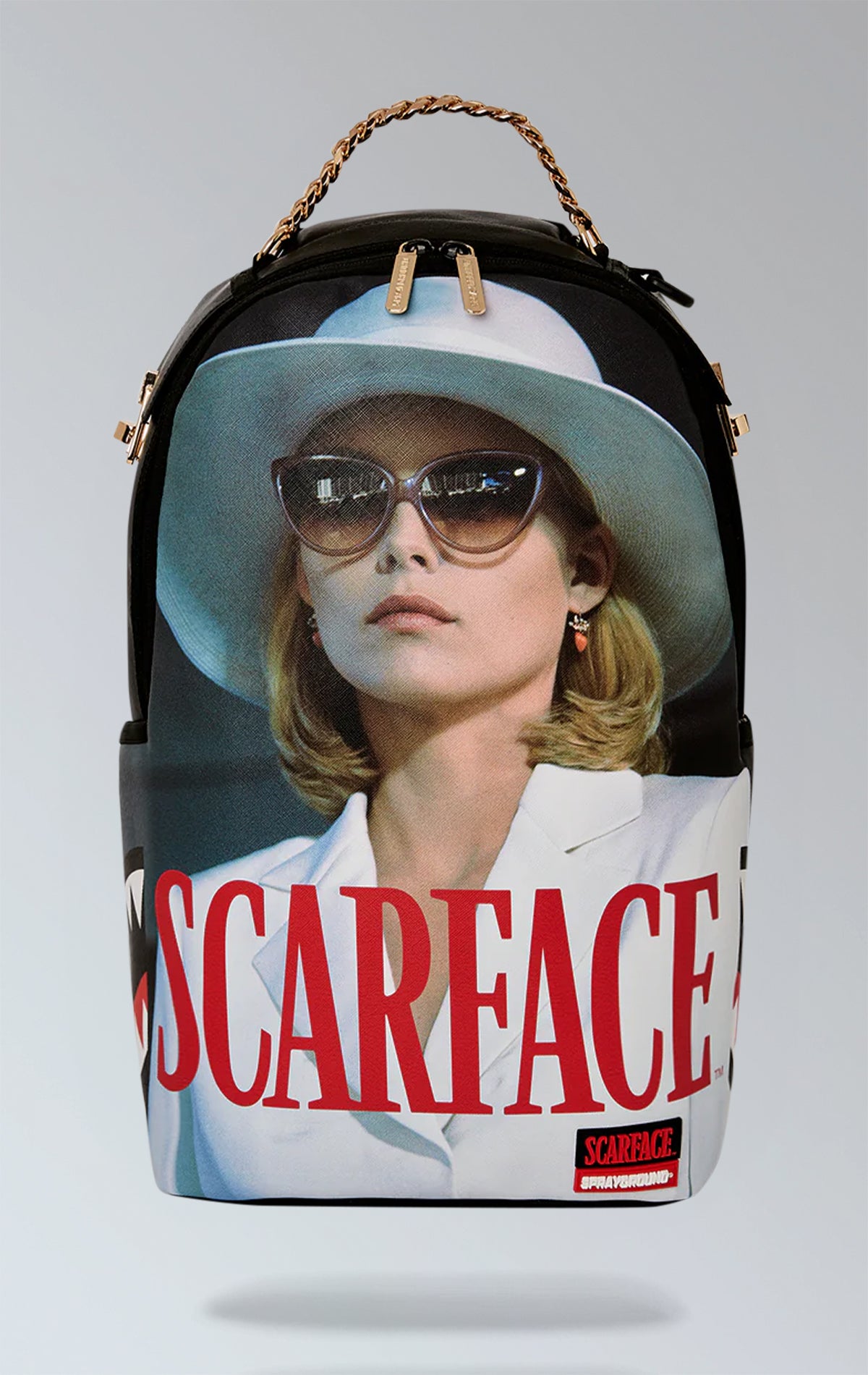 SCARFACE MICHELLE PFEIFFER BACKPACK. Exterior: Measurements: 18" x 6" x 11.5" Front zip pocket, side pockets, stash pocket with zipper. Separate compartment for sunglasses with velour lining, comfortable padded mesh back. Flexible straps for personalized fit. Gold zippers and metal hardware. "Sprayground Authentic" badge in metal. Back sleeve with strap attaches to carry-on luggage for hands-free travel.