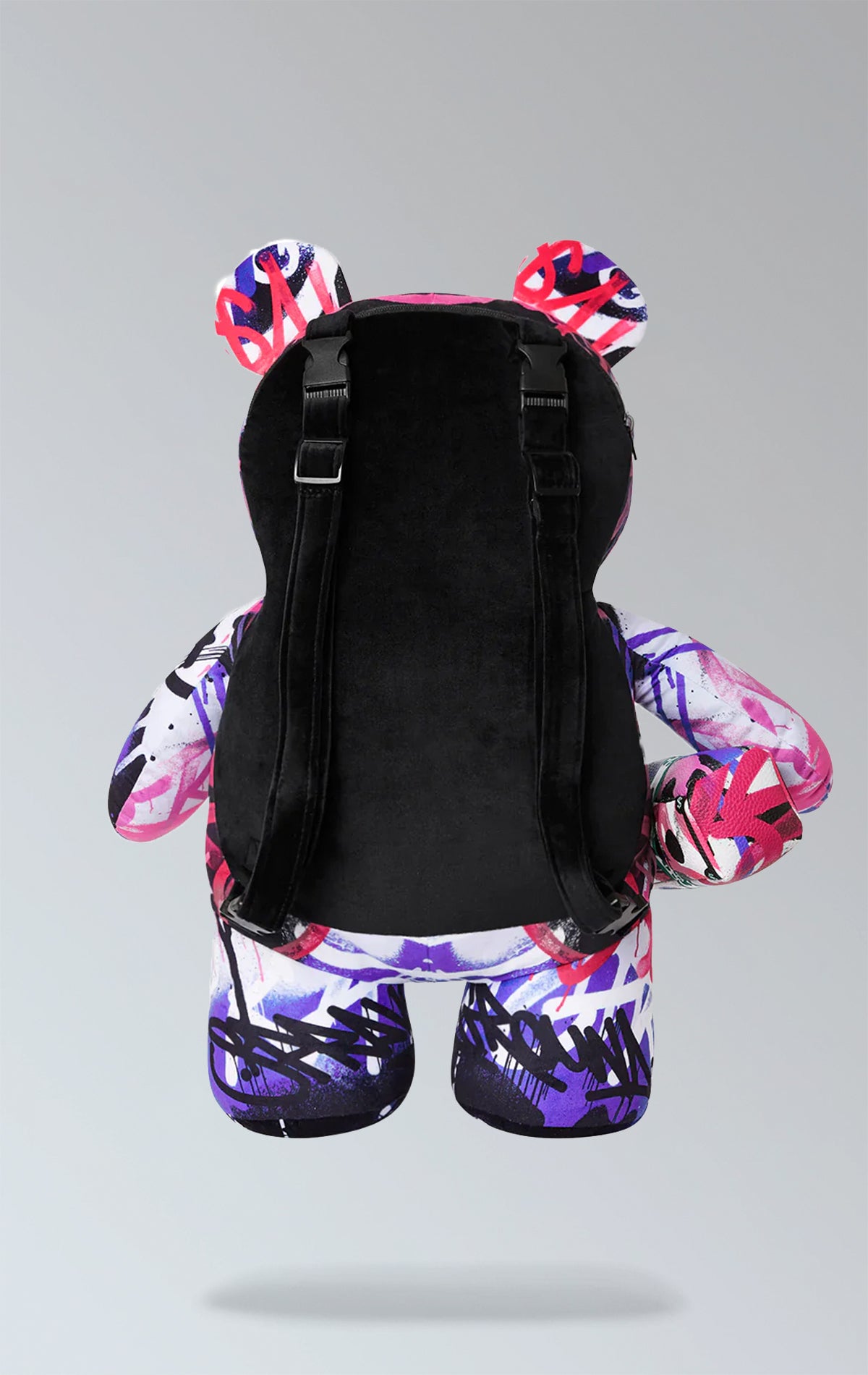 Sprayground purple backpack with Money Bear design, featuring a zippered pocket on the belly, zippered pockets on each arm, a large zippered pocket on the back panel, and adjustable straps. Made from durable water-resistant polyester velour fabric.