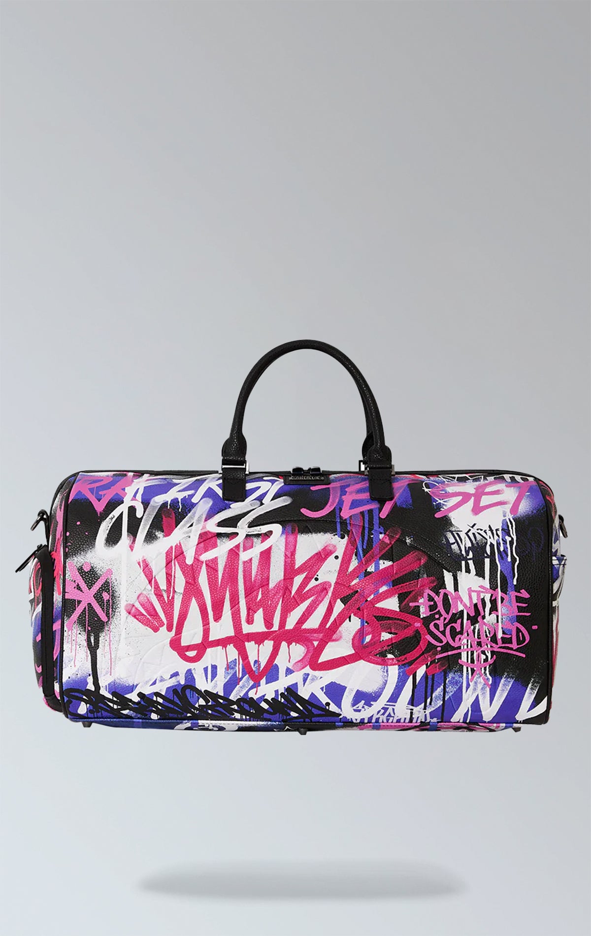 Purple duffle bag with Vandal Couture design, featuring multiple compartments including a metal zipper pocket, back zippers, and a zippered sneaker pocket. It has gold zippers, adjustable straps, and metal hardware. Made from durable water-resistant vegan leather.
