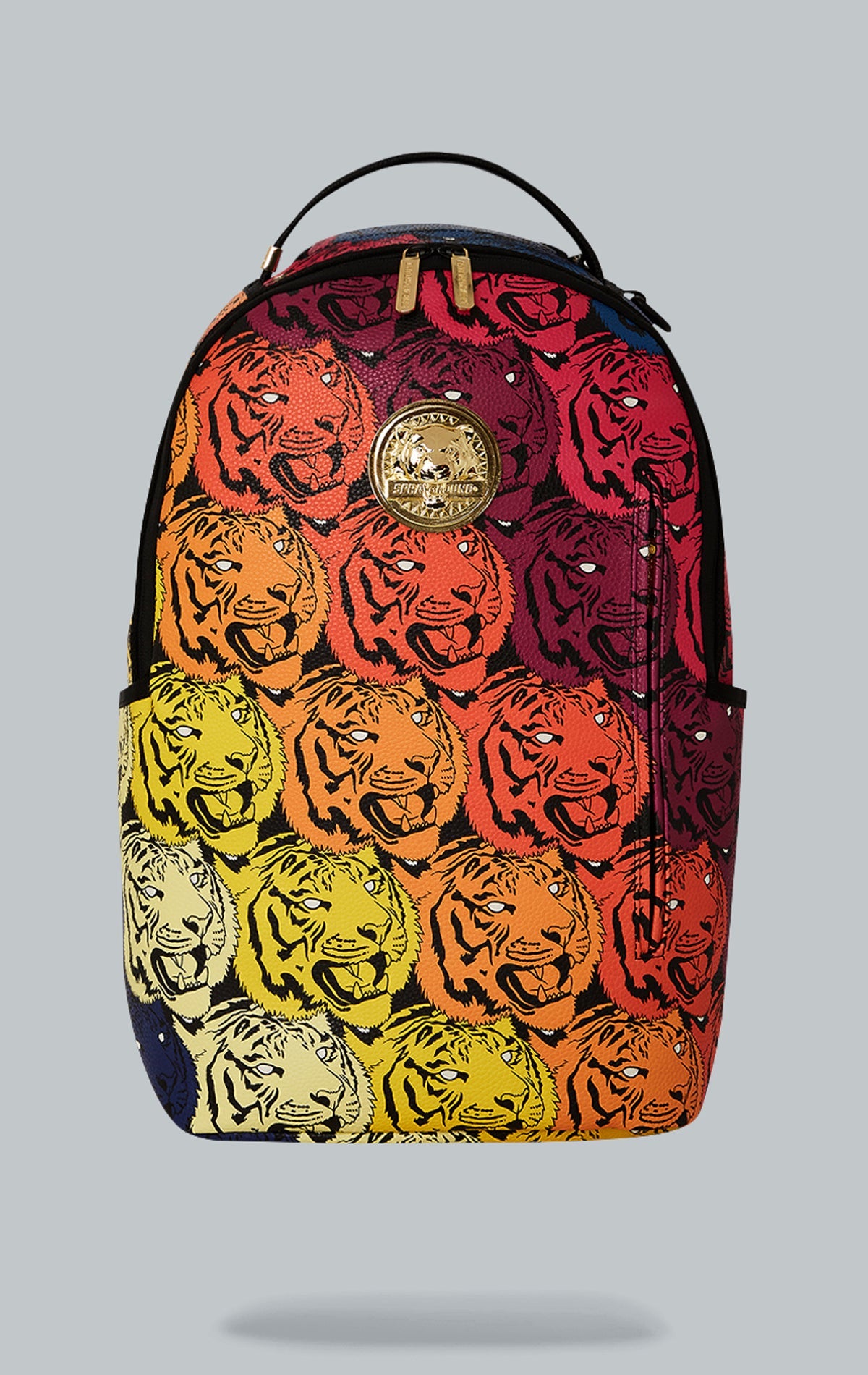 Sprayground Tigers on My Mind Backpack. The backpack is made from durable faux leather (100% PVC) and features a gold metal plated tiger emblem, a front zipper pocket, side pockets, a zippered stash pocket, a separate velour sunglass compartment, ergonomi