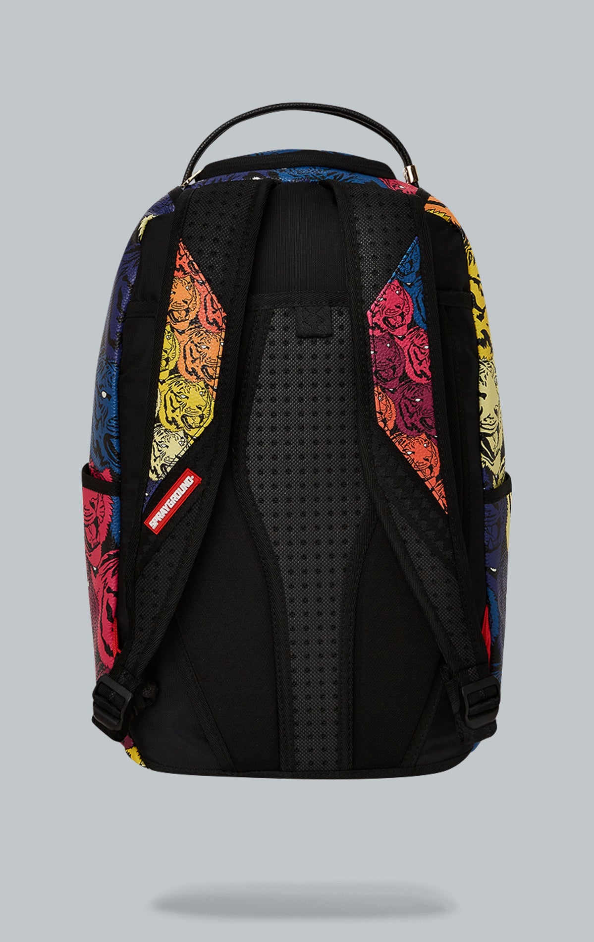 Sprayground Tigers on My Mind Backpack. The backpack is made from durable faux leather (100% PVC) and features a gold metal plated tiger emblem, a front zipper pocket, side pockets, a zippered stash pocket, a separate velour sunglass compartment, ergonomi