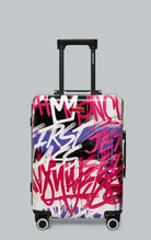 Sprayground Vandal Couture Carry On luggage in black with a patented shark sculpture. The carry-on features a hard-shell exterior, TSA security locks, a telescoping handle, four dual-spinning wheels, and a zipperless aluminum alloy frame. The interior fea