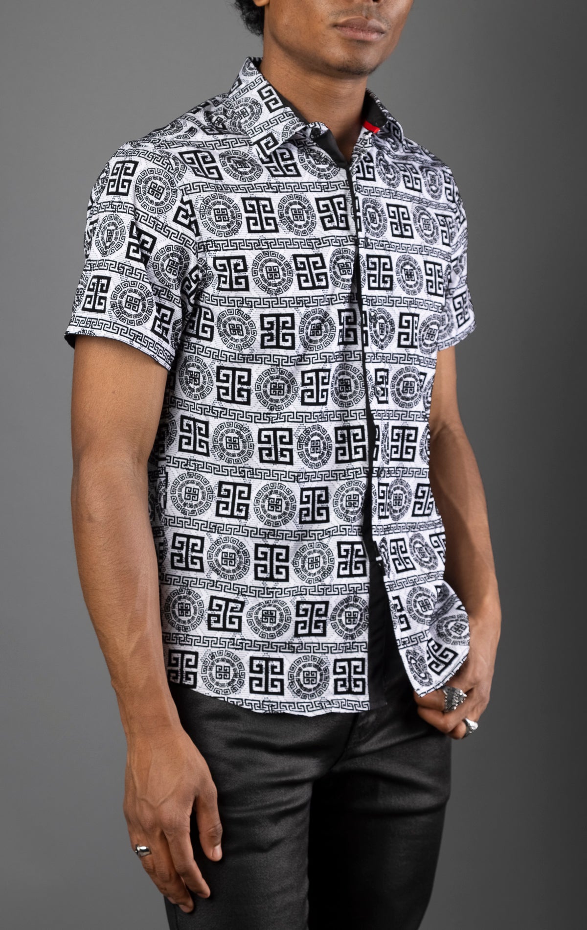 Men's casual button-down shirt in a relaxed fit with short sleeves. The shirt features a stylish pattern and a front button closure.