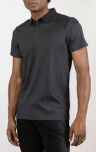 Men's versatile stretch polo shirt in black. The polo is made from an 87% nylon, 13% spandex blend and features a seamless pattern design, a classic polo collar with buttons, and short sleeves.