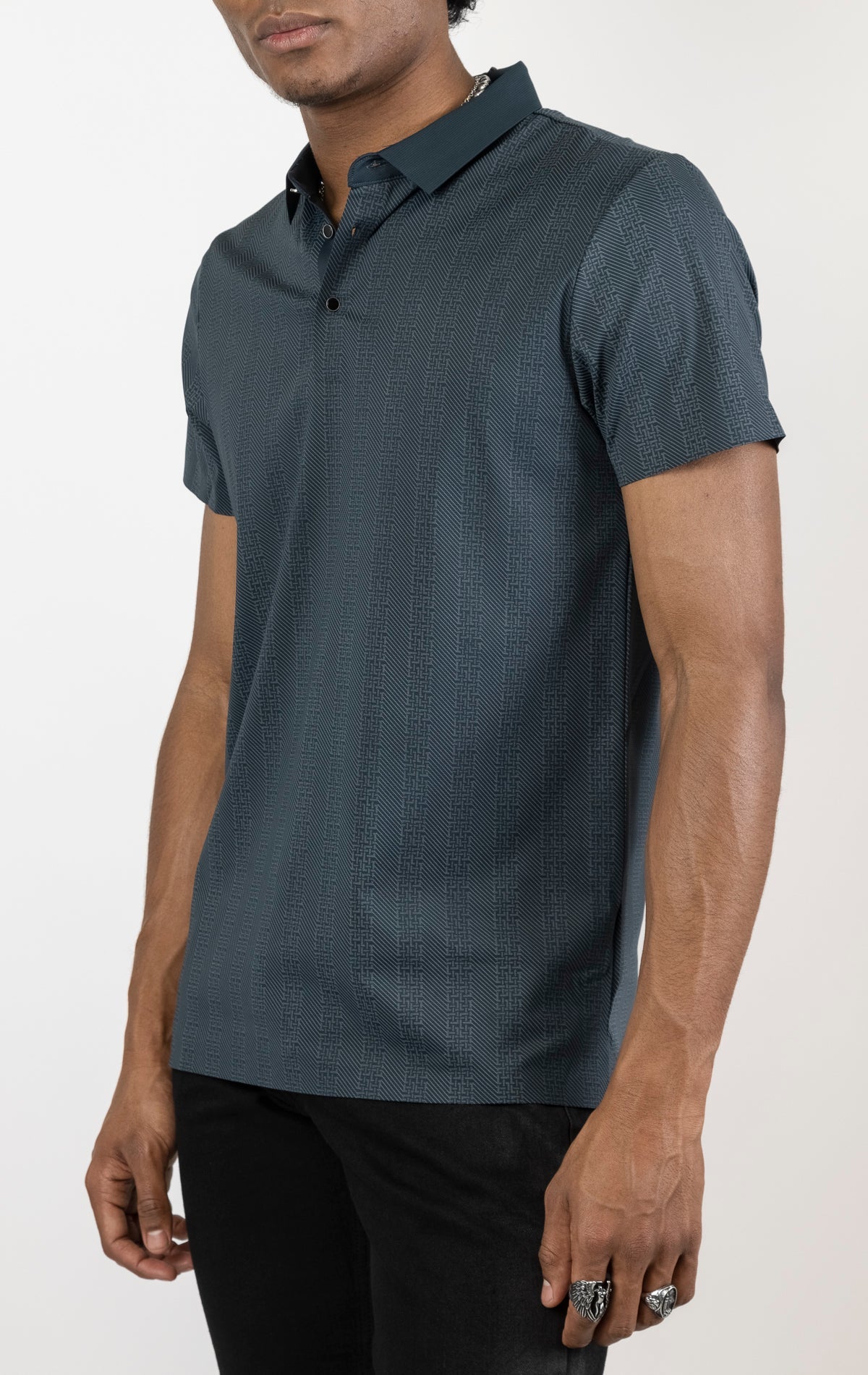 Men's versatile stretch polo shirt in navy. The polo is made from an 87% nylon, 13% spandex blend and features a seamless pattern design, a classic polo collar with buttons, and short sleeves.